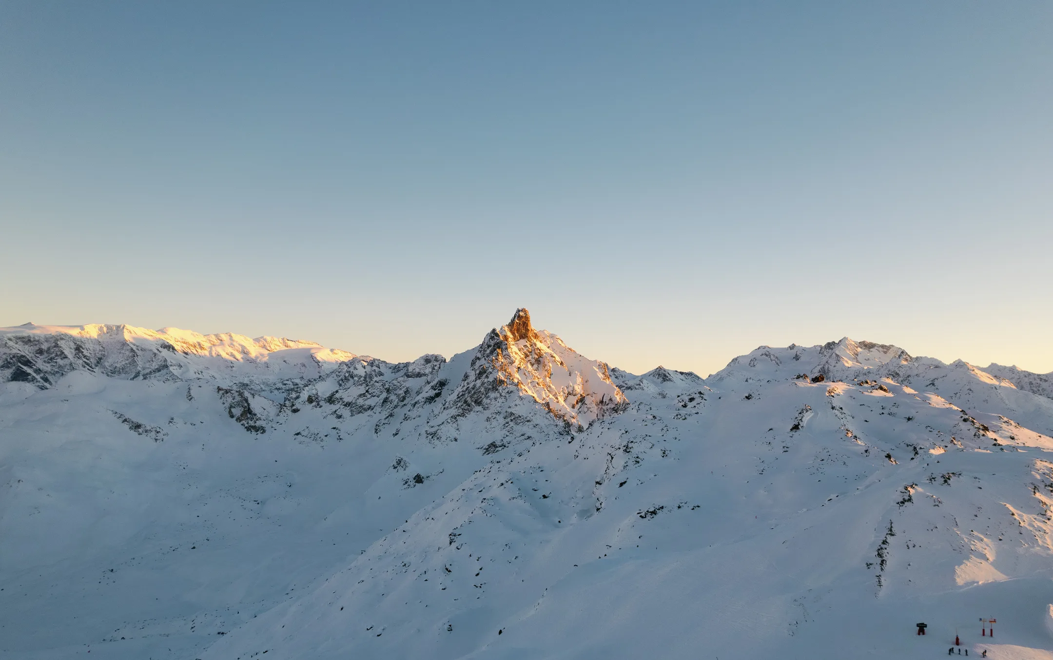 Snow-covered mountains in Courchevel during winter at sunset.